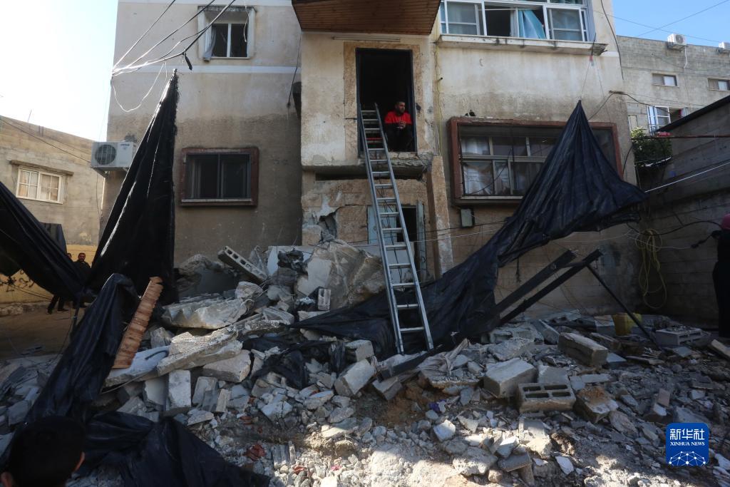 12月17日，在約旦河西岸城市圖勒凱爾姆附近的一處難民營，人們查看在沖突中損毀的房屋。新華社發(fā)（尼達爾·艾仕塔耶攝）