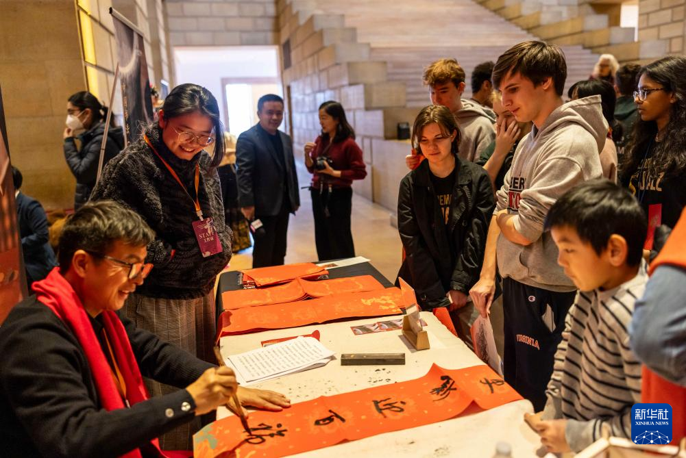 2月11日，書(shū)法家在美國(guó)費(fèi)城藝術(shù)博物館舉行的龍年迎新春活動(dòng)上為參觀者書(shū)寫(xiě)對(duì)聯(lián)。新華社發(fā)（周煥新攝）