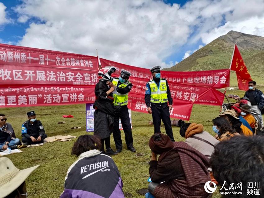 給牧民講如何佩戴安全頭盔。巴登攝